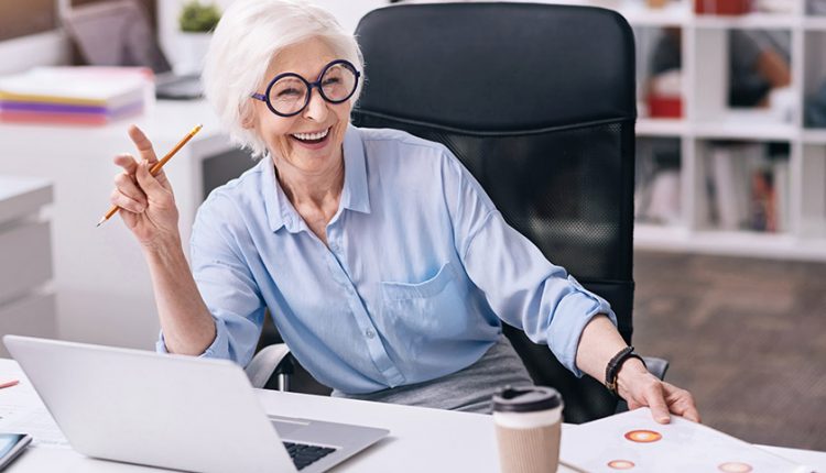 Senior woman working in an office and smiling