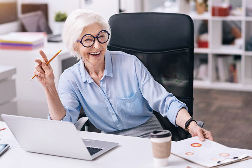 Senior woman working in an office and smiling