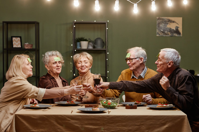 A group of seniors at a party, playing a guessing game