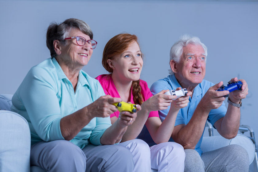 Grandparents playing a video game with their granddaughter