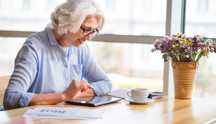 Senior businesswoman happily working in retirement with good time management