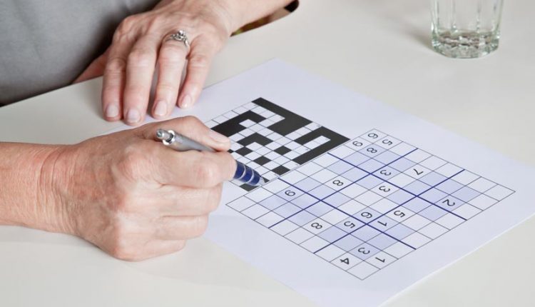 A senior solving a Sudoku puzzle