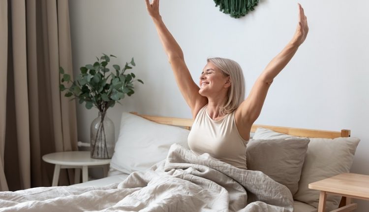 a senior adult waking up from a good night's sleep