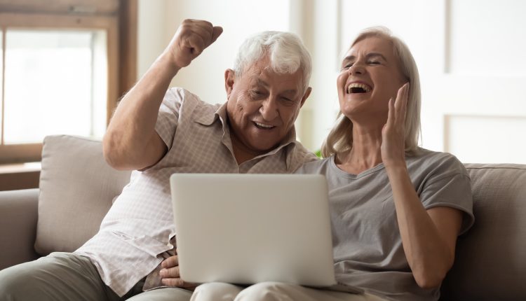 Excited and Happy Senior Couple on the Laptop