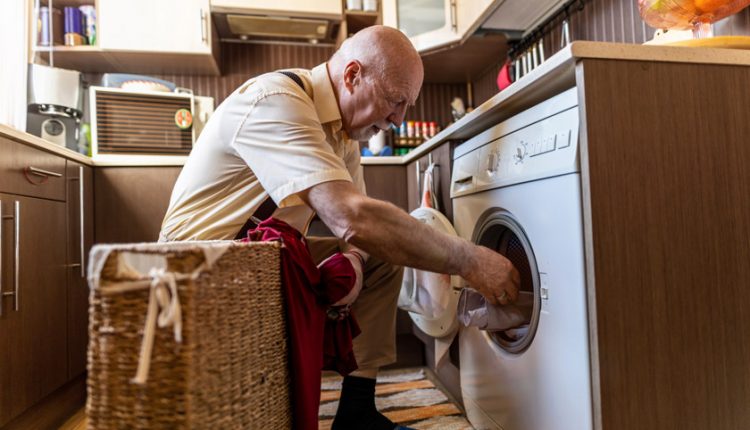 Senior man doing laundry