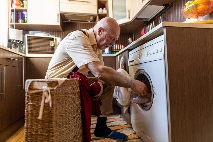 Senior man doing laundry