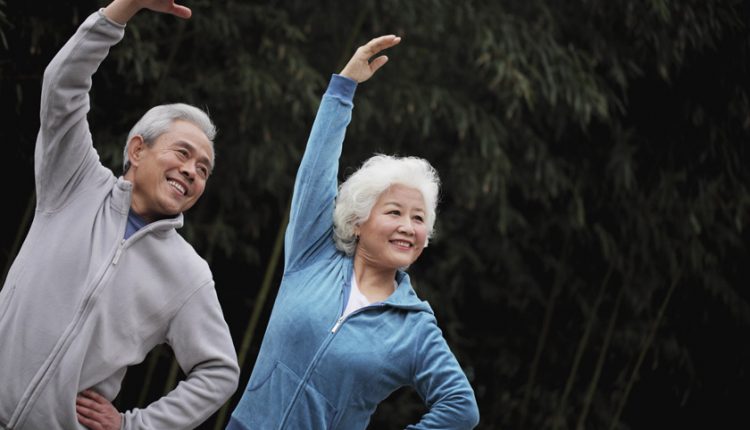 Senior couple exercising together in a park