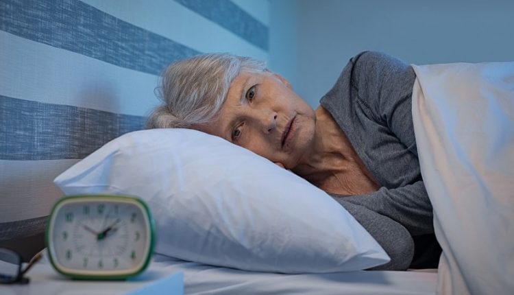 An elderly person who struggles to sleep
