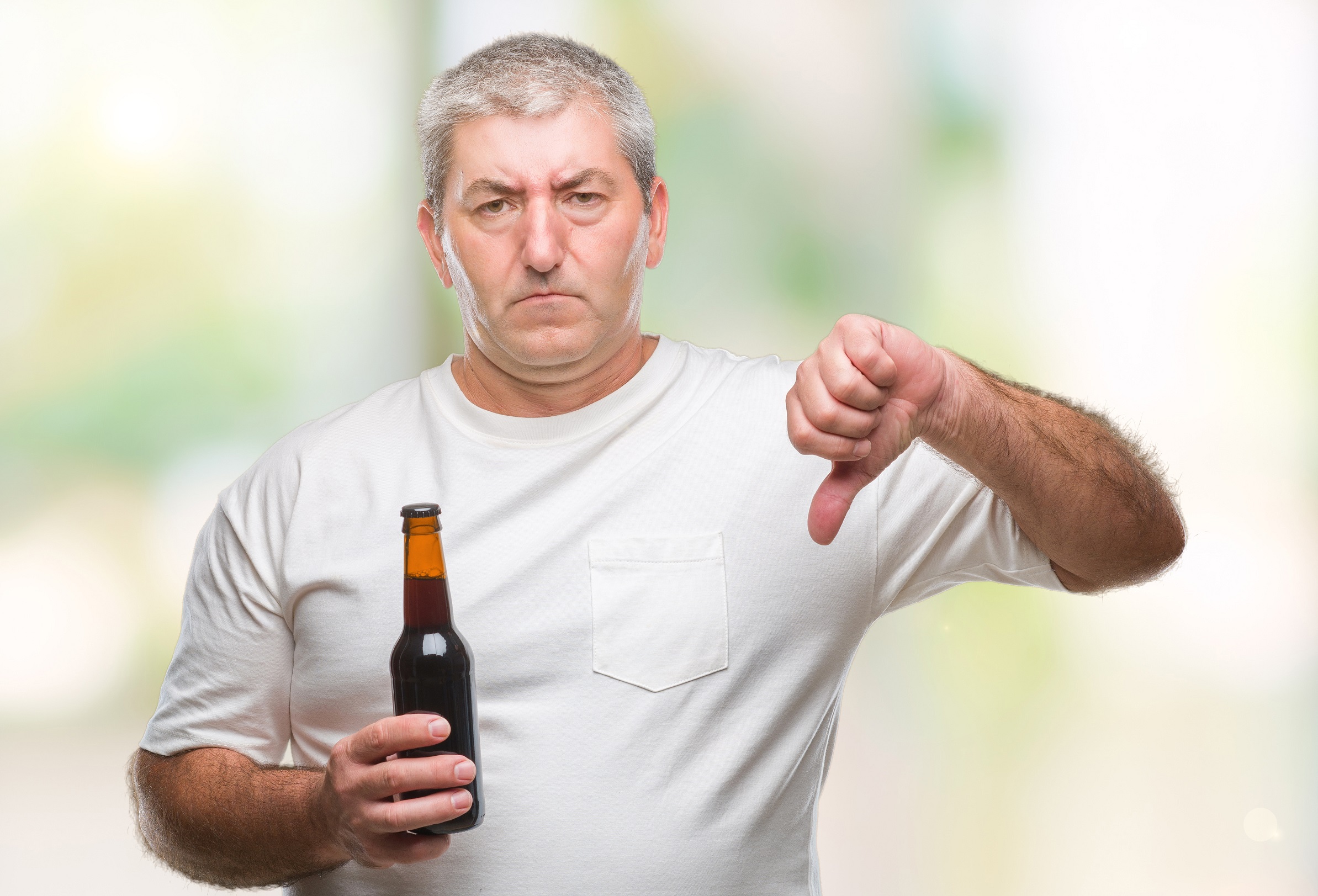 Seniors man holding beer bottle, alcohol related dementia