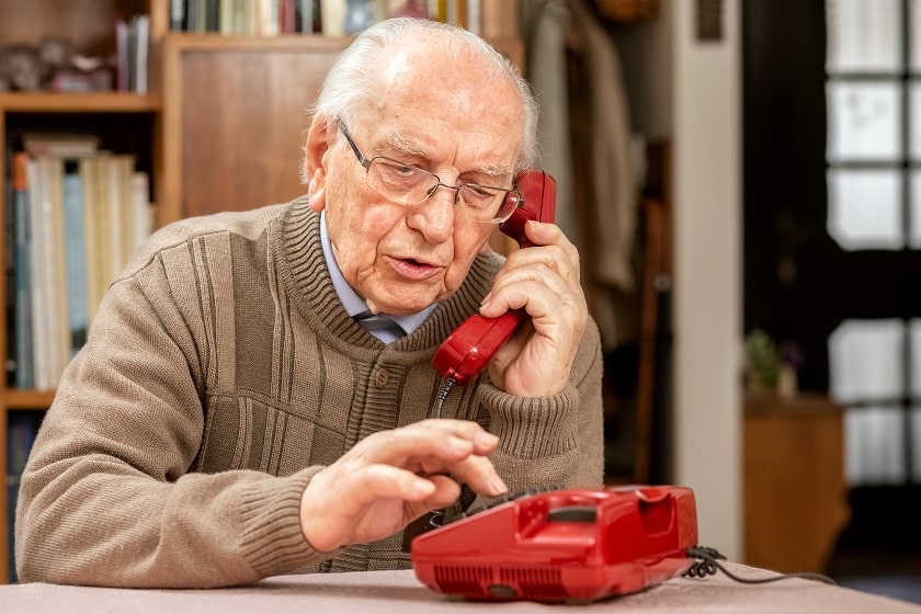 a senior with his dementia-friendly home phone