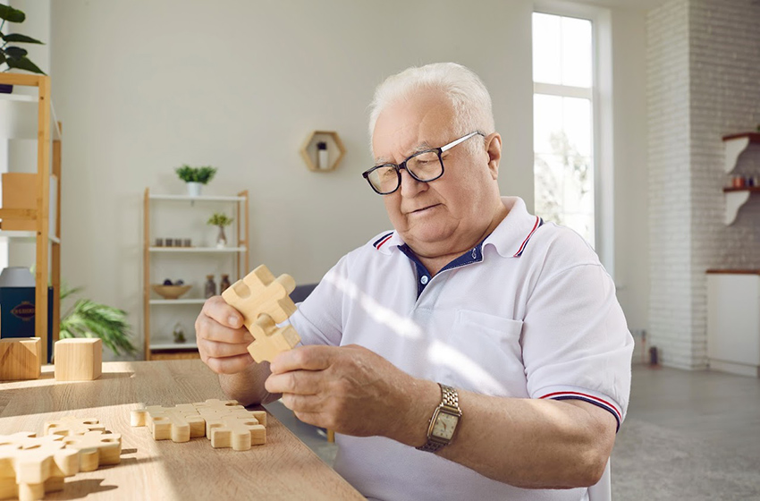 Alzheimer's patient assembling wooden puzzles