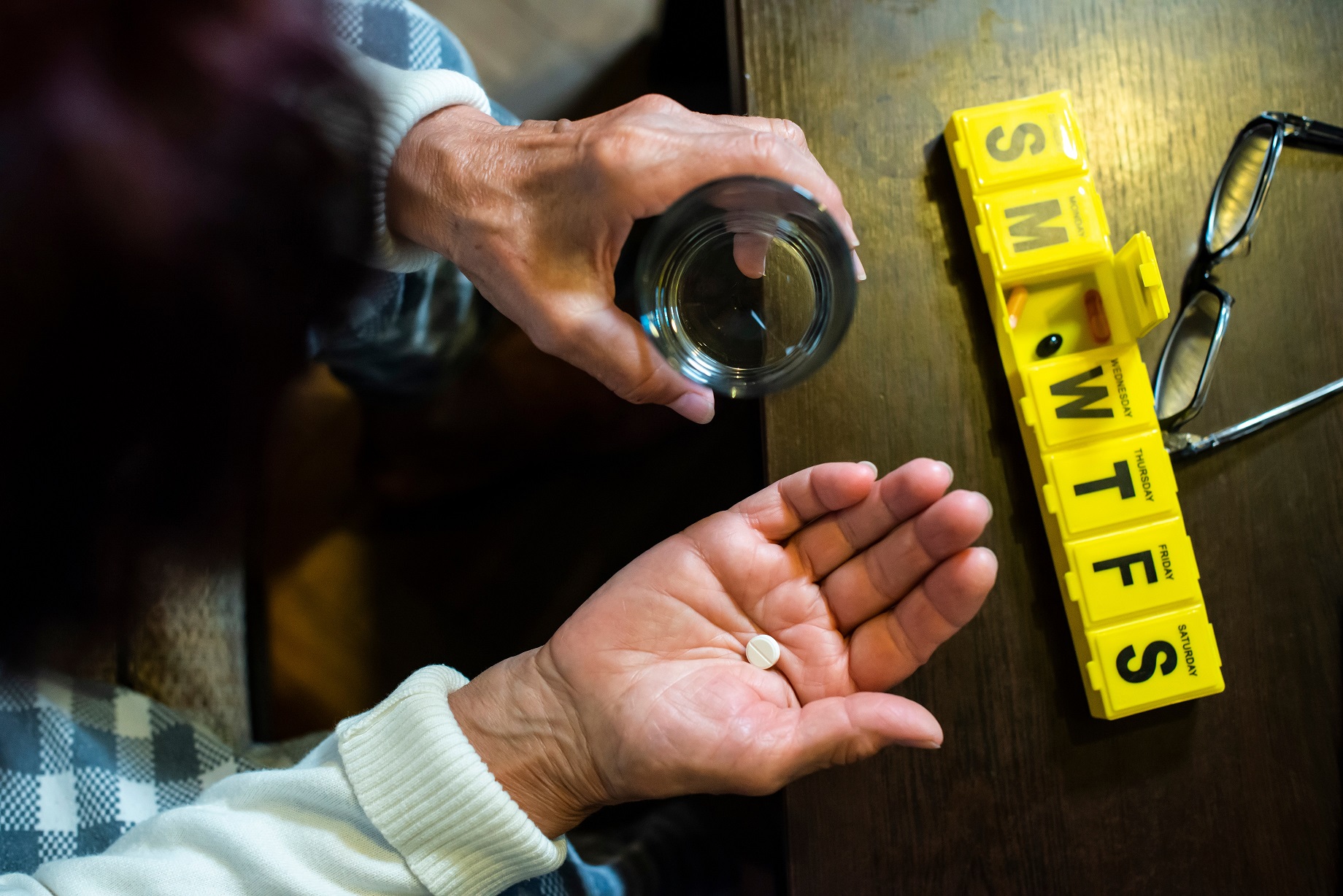 elderly person taking medicine 