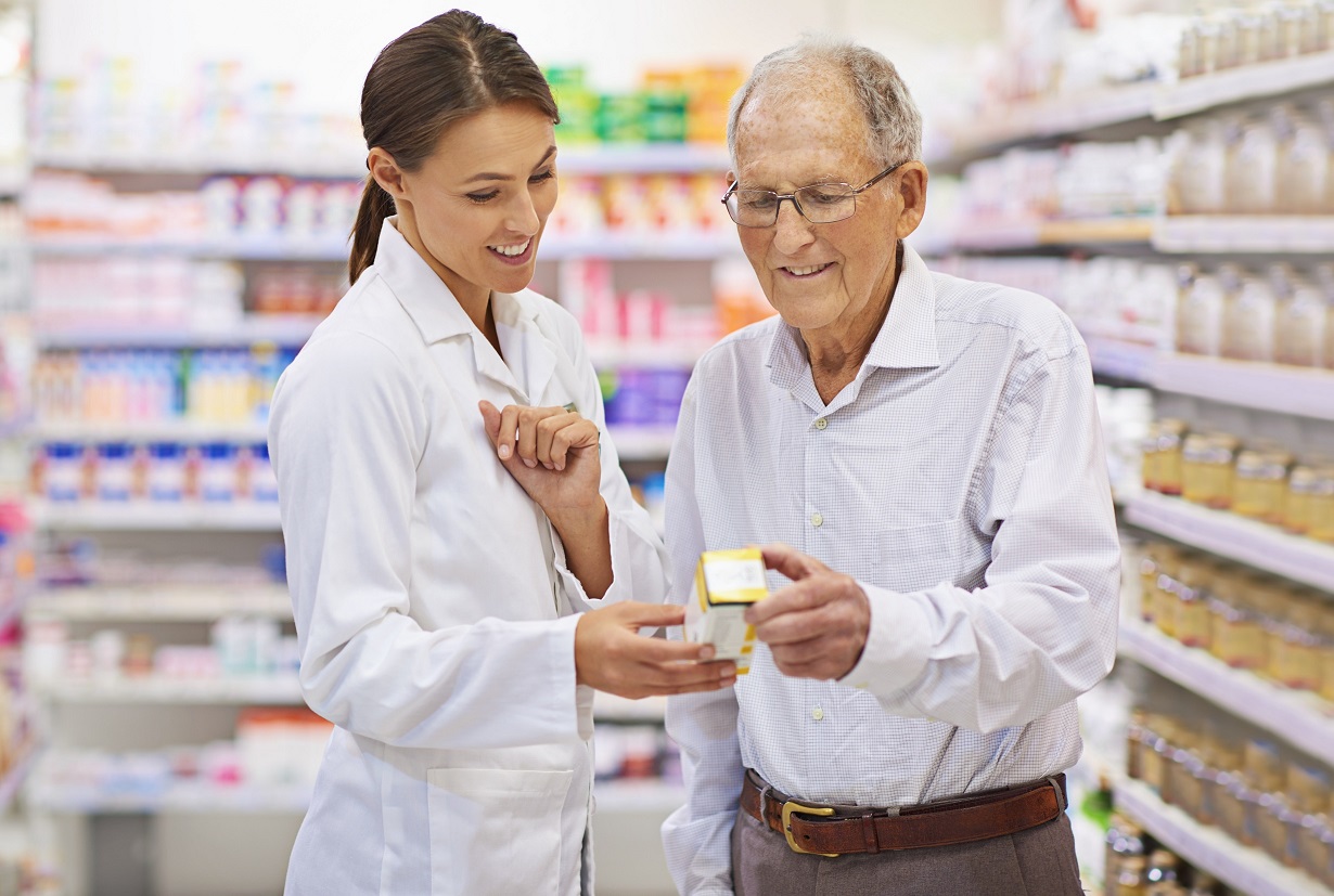 Taking the questions out of medication. Shot of a young pharmacist helping an elderly customer.