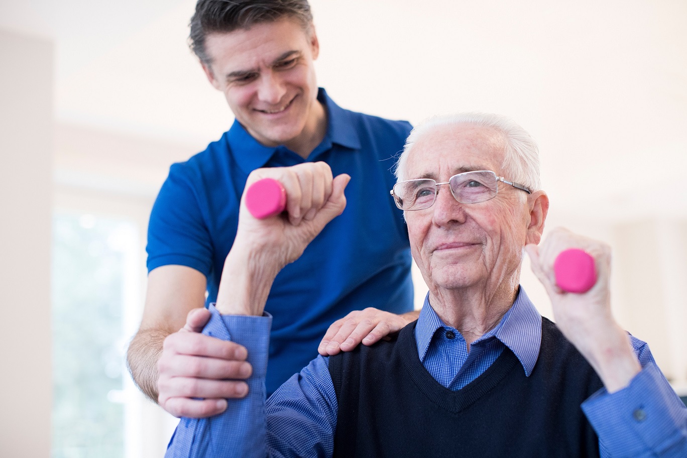 vascular dementia, Physiotherapist Helping Senior Man To Lift Hand Weights