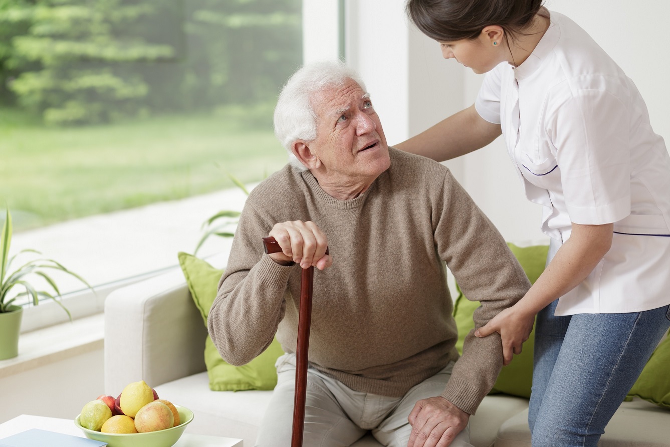 Alzheimer's and Parkinson's, Young woman helping old man to stand up