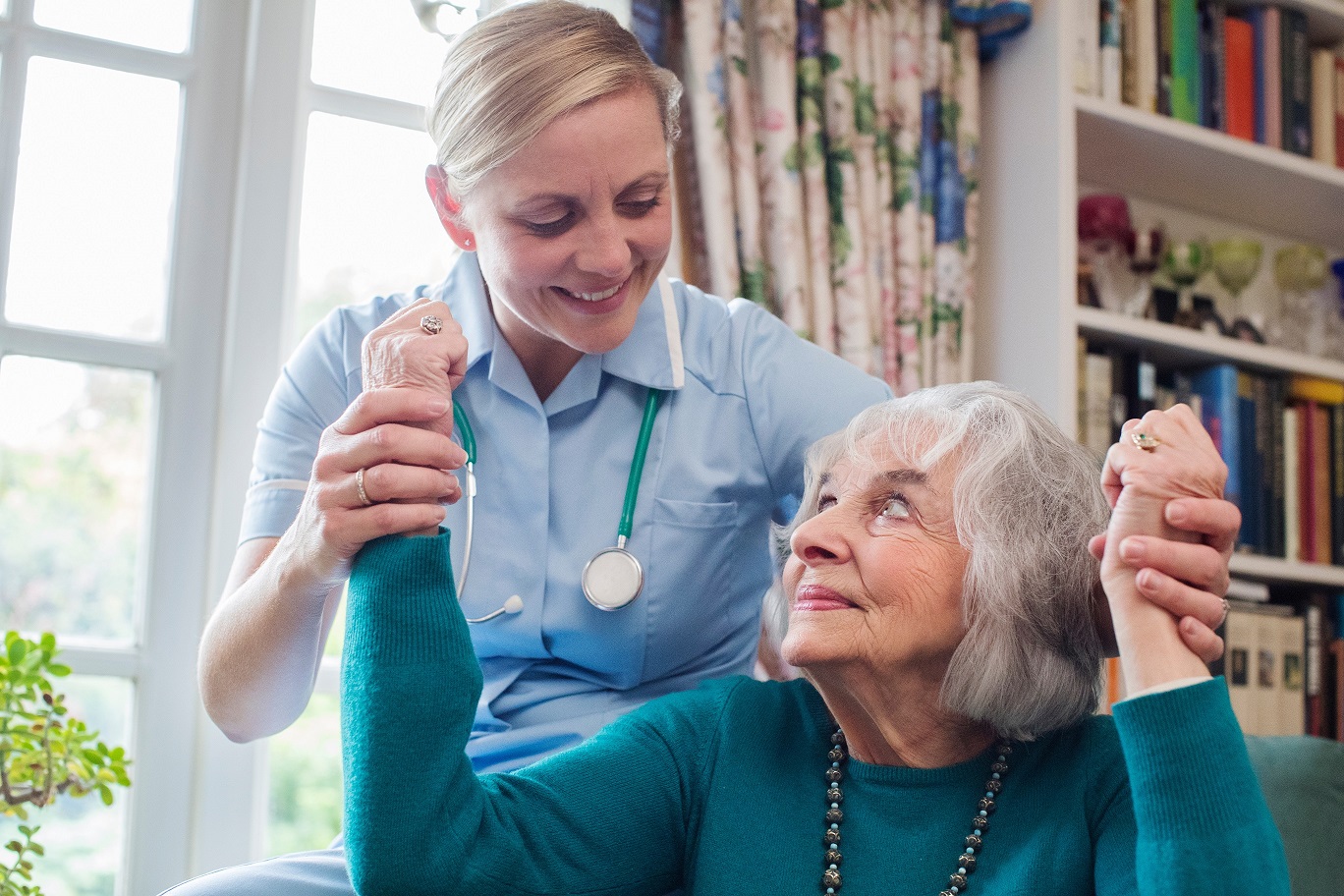 Nurse Assessing Stroke Victim By Raising Arms