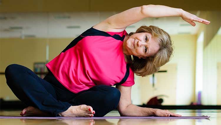 Middle age lady doing exercise on a mat