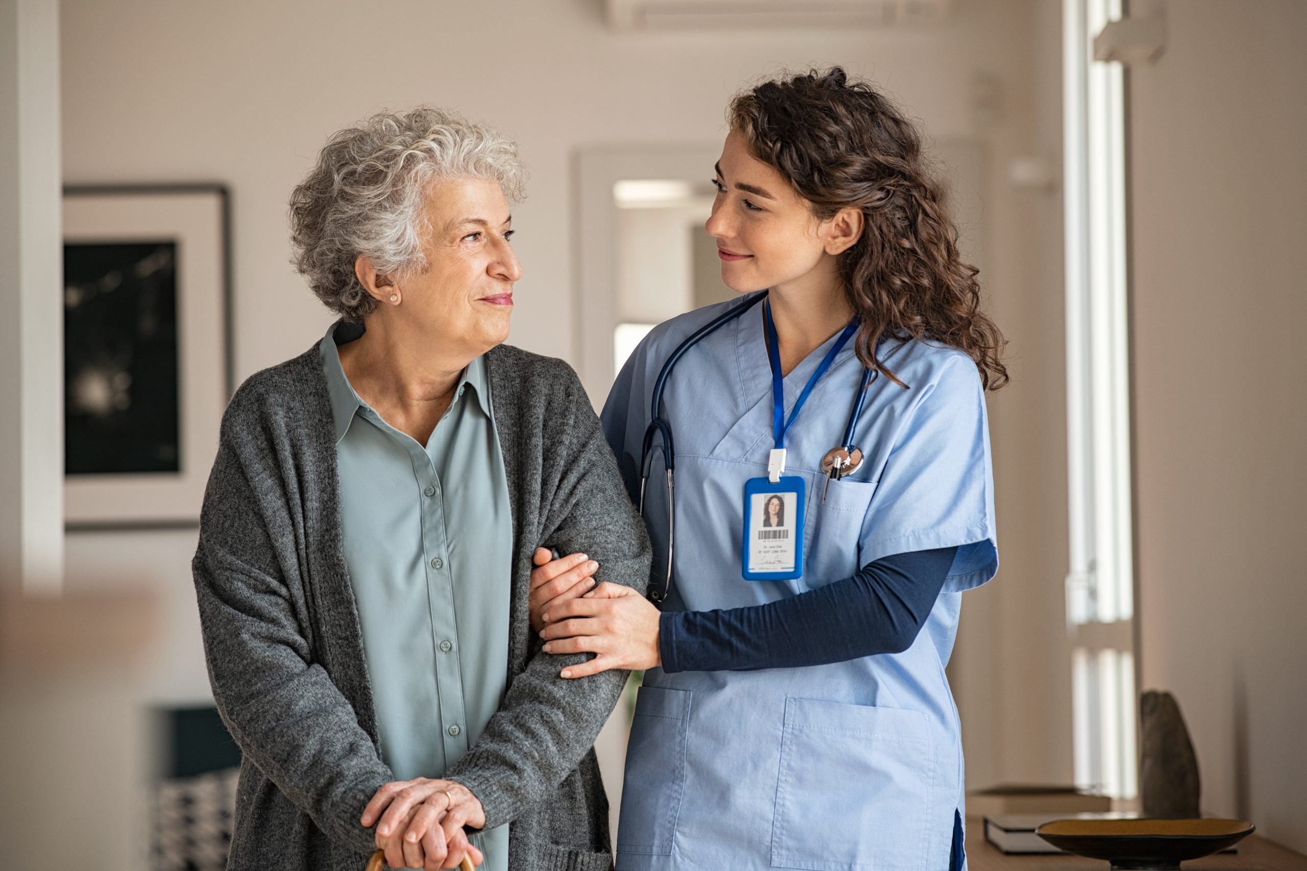 Young nurse walking with a senior lady