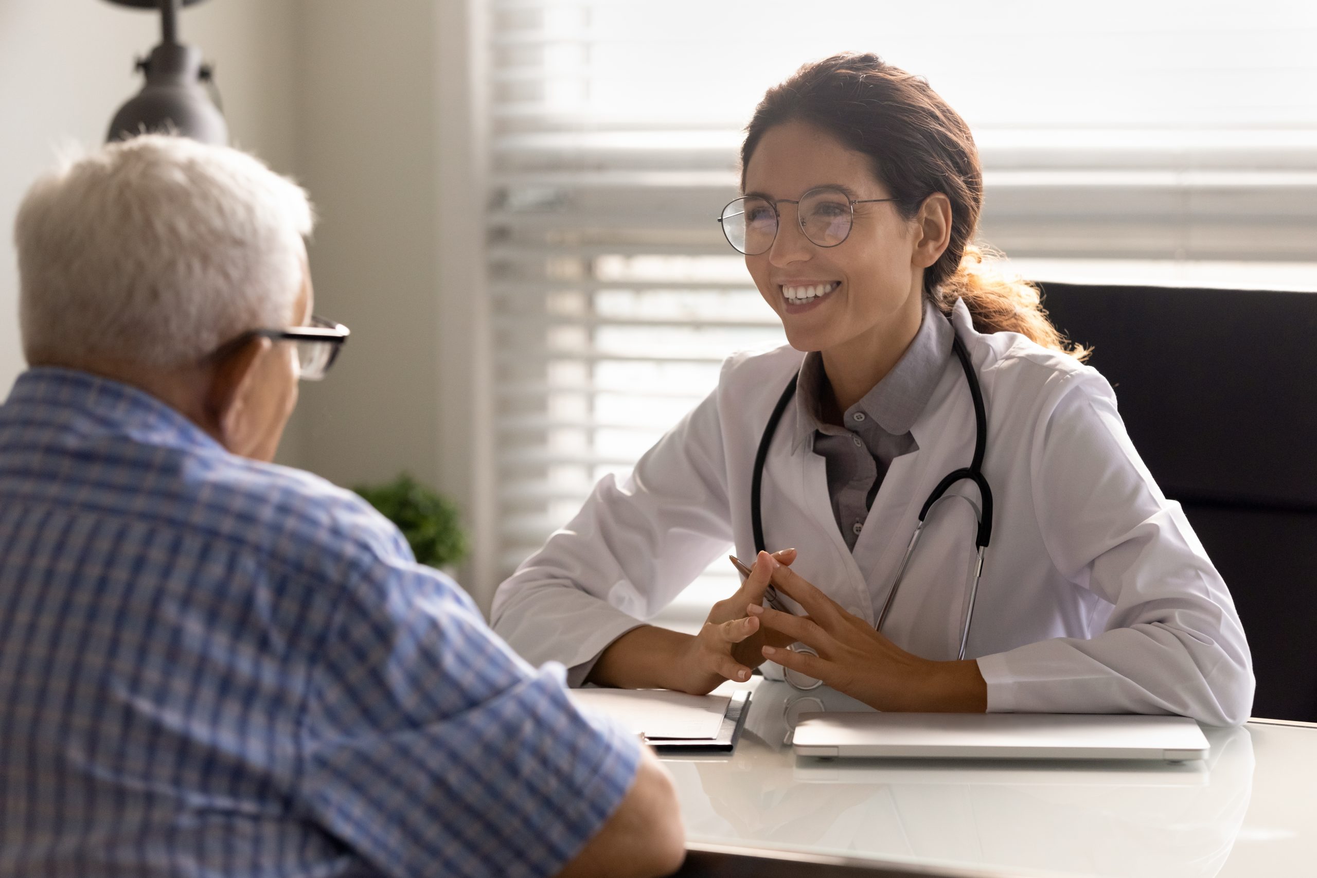 Young doctor talking to a senior patient