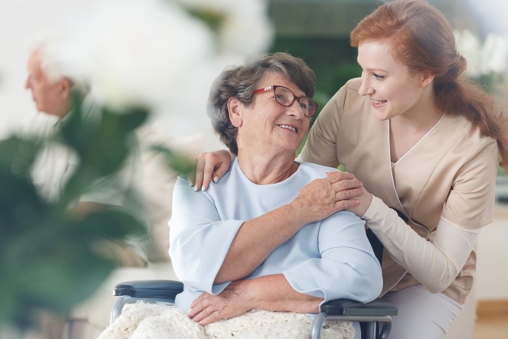 Old,Lady,In,Glasses,Sitting,In,A,Wheelchair,And,Smiling